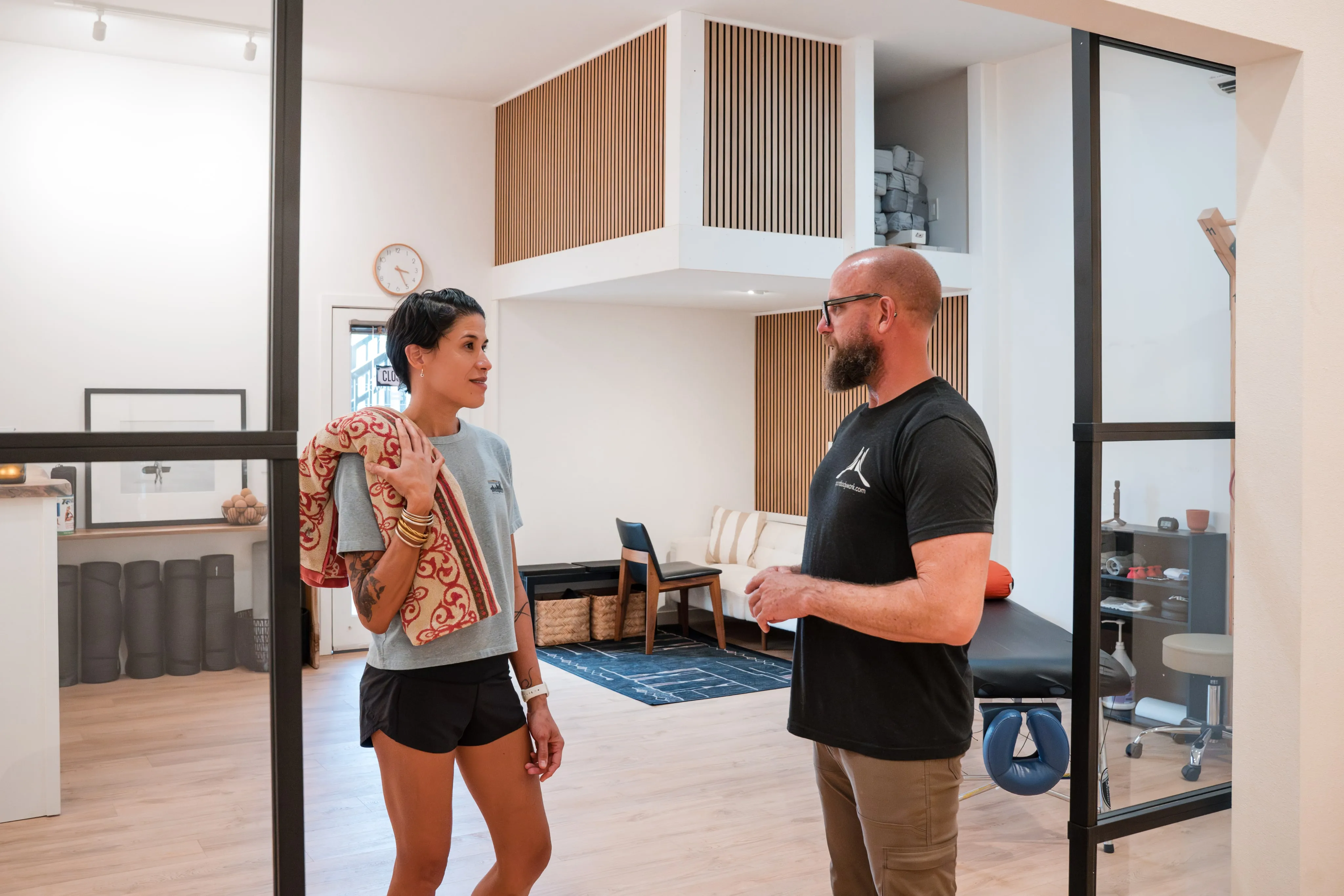 A SportBodyWork specialist talking with a client in the studio